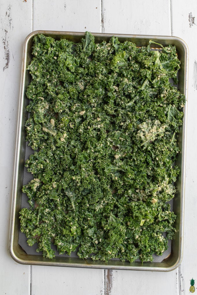 Vegan ranch kale chip on baking sheet before going into the oven by sweet simple vegan