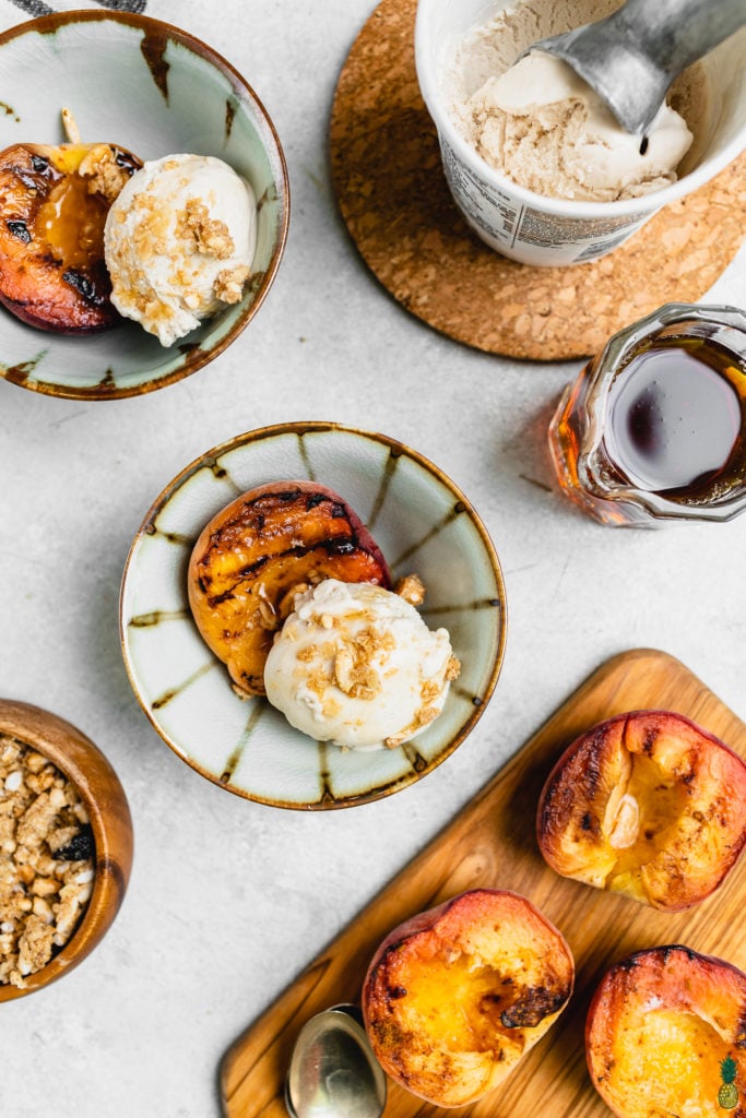 Maple glazed grilled peaches in a cup with vegan ice cream 