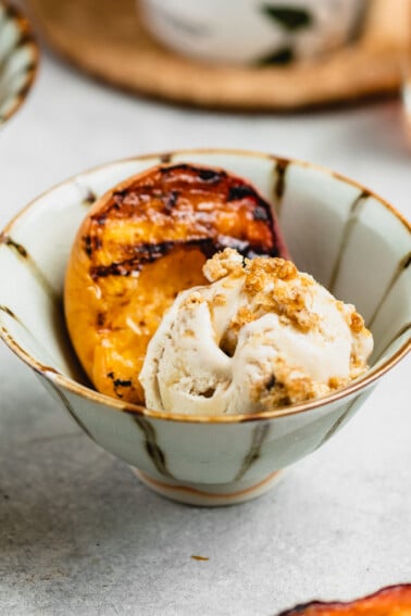 Maple glazed grilled peaches in a cup with vegan ice cream