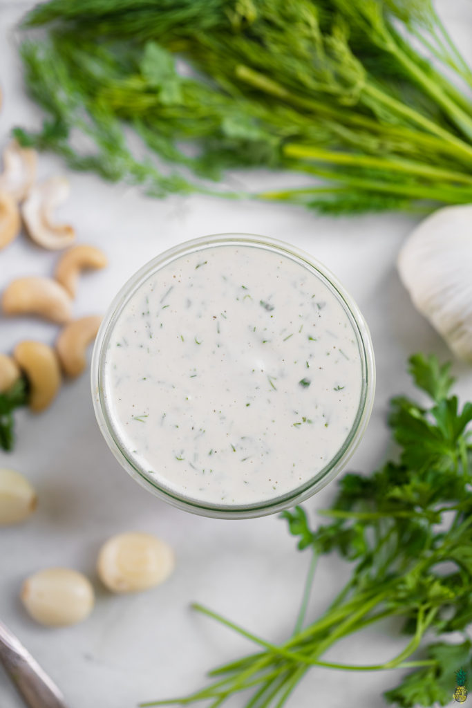 Overhead shot of a cashew ranch dressing in a cup by sweet simple vegan