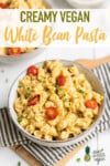 5-ingredient creamy white bean pasta in a bowl close up with tomatoes on top pinterest by sweet simple vegan
