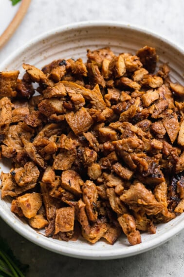 Closeup shot of chopped vegan carne asada taco meat by sweet simple vegan