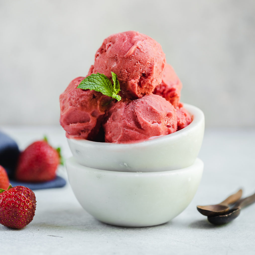 strawberry frozen yogurt in white bowls food photography by sweet simple vegan