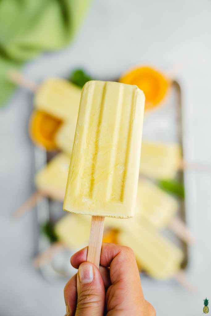 hand holding a vegan creamsicle popsicle 5 ingredients