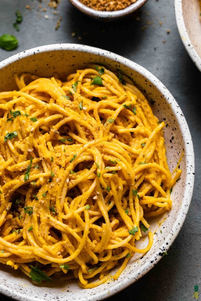 a close up shot of creamy vegan squash pasta with parmesan and white wine by sweet simple vegan