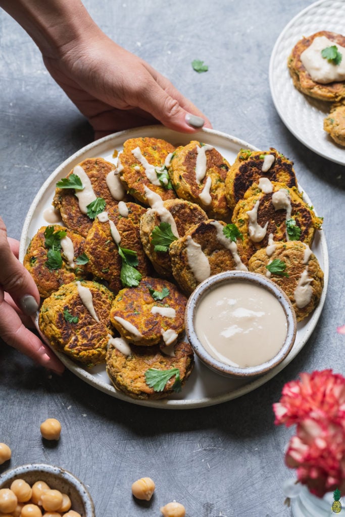 vegan pumpkin chickpea fritters with hummus and cilantro
