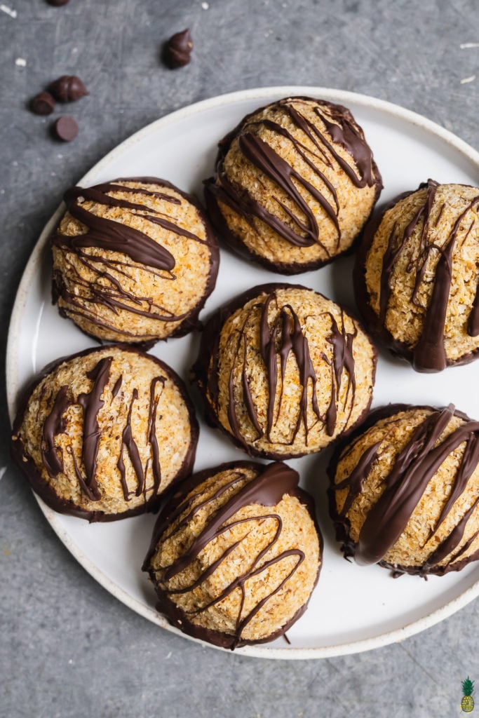 Chocolate Dipped Pumpkin Macaroons on a white marble plate