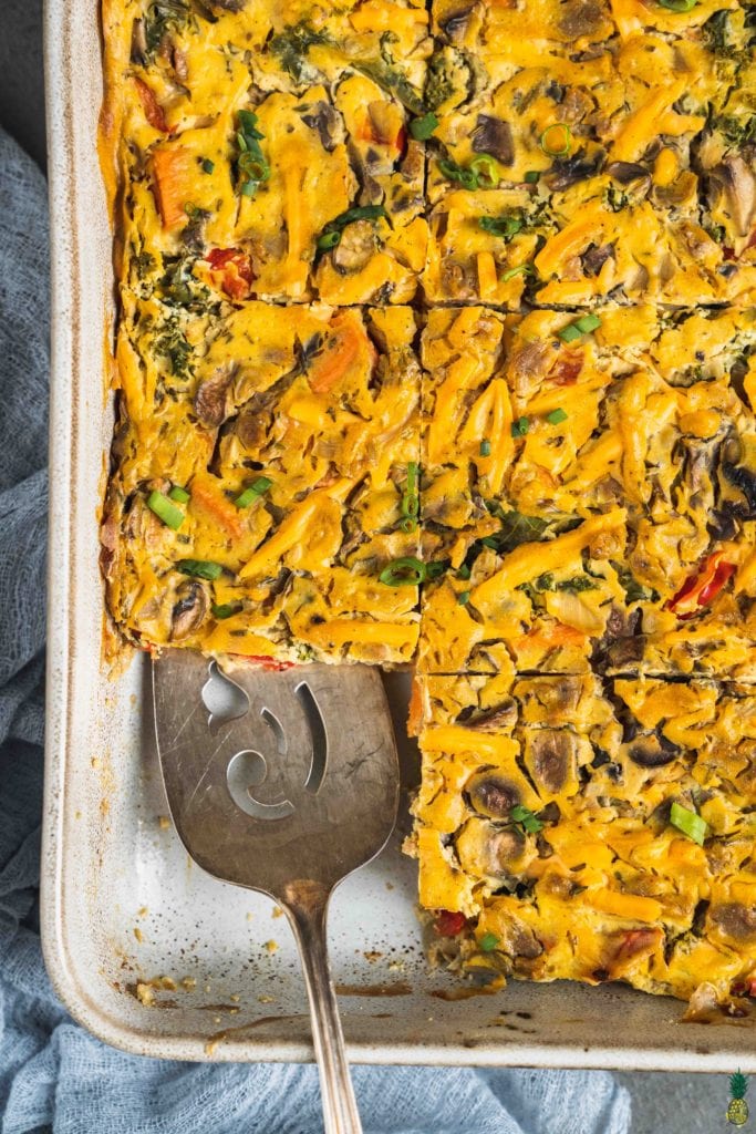 Christmas Recipe - Overhead shot of a cut vegan sweet potato breakfast casserole in a white dish by sweet simple vegan