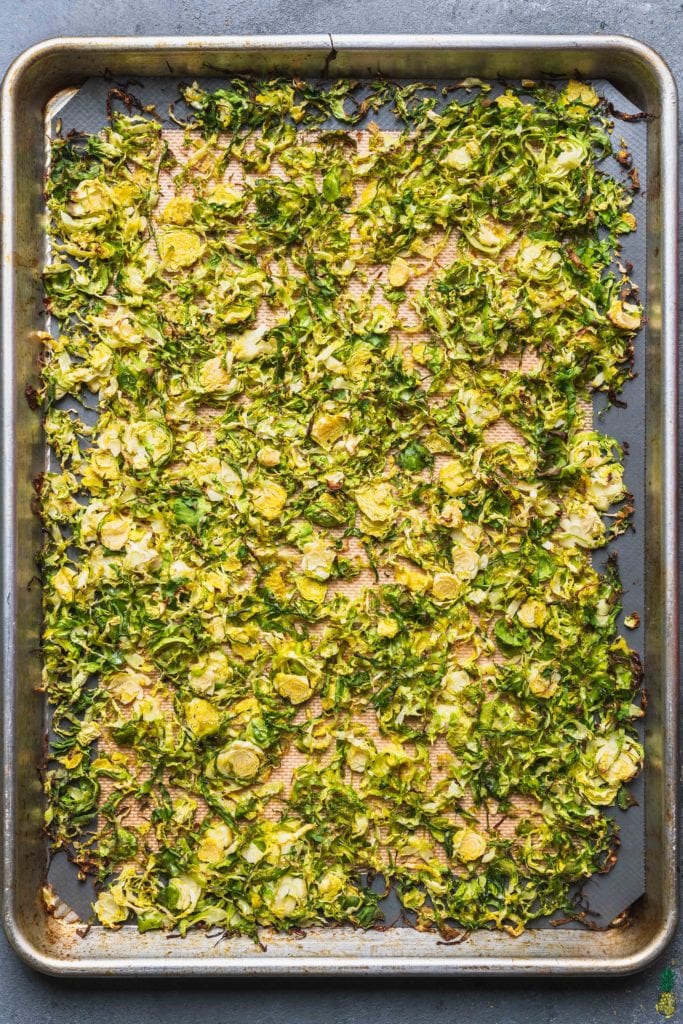 over head photo of roasted brussels sprouts in a baking dish