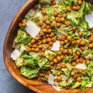 over head of brussels sprouts caesar salad in large wooden bowl