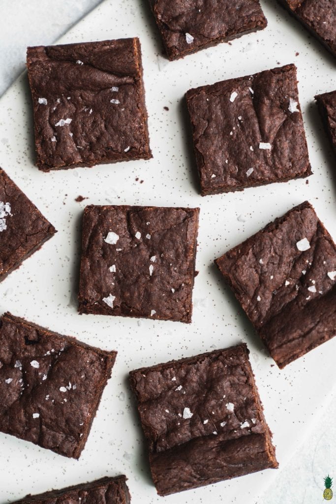 vegan brownies with maldon salt on a marble platter by sweet simple vegan