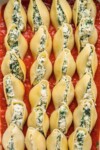 a close up shot of vegan ricotta spinach stuffed shells with homemade marinara before baking by sweet simple vegan