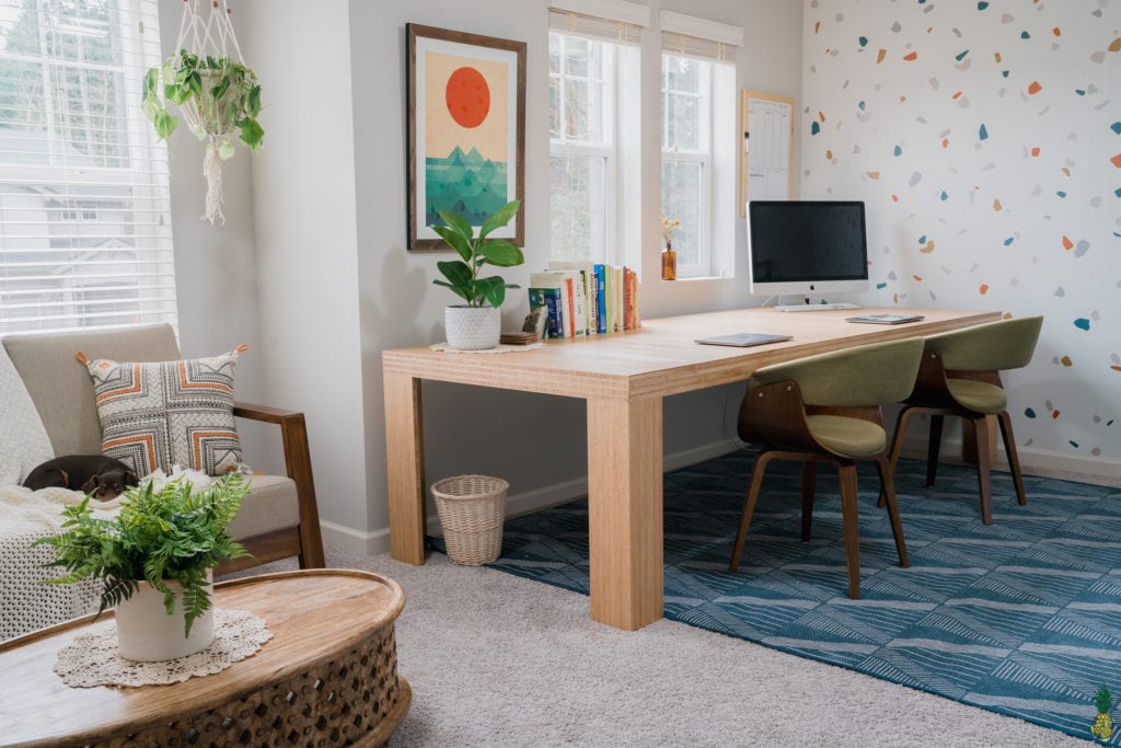 image of home office with desk, couch, and table.