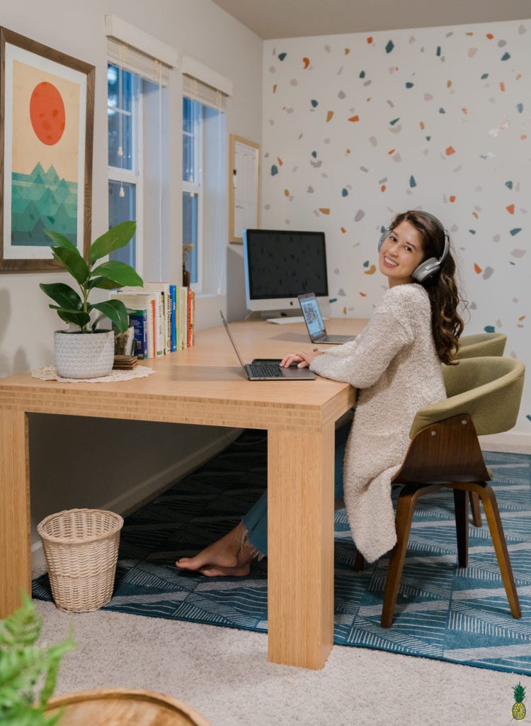 Jasmine sitting at the desk with her computer working