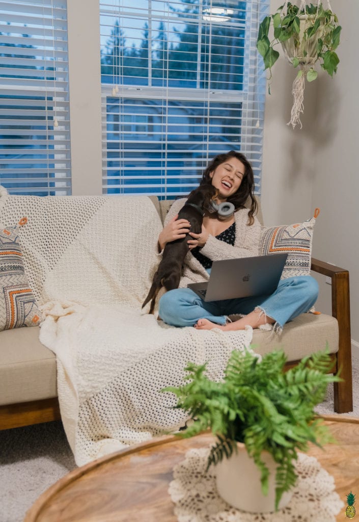 Jasmine sitting on the couch with Berry and her computer.