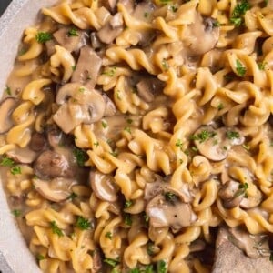 overhead close up image of mushroom stroganoff with wooden spoon