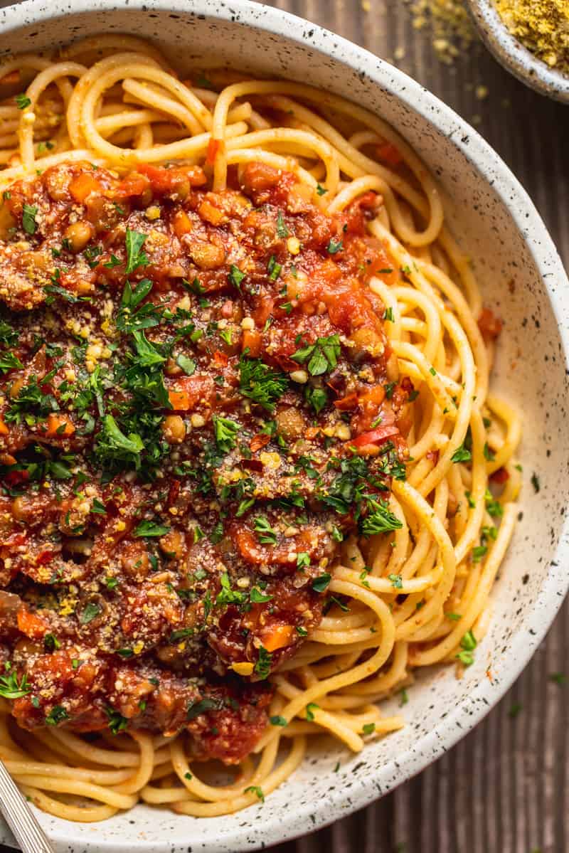 Close up of vegan bolognese​ Sauce on spaghetti in white bowl