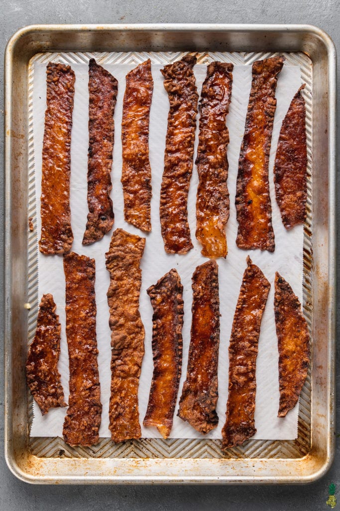 baked crispy vegan rice paper bacon on a baking sheet by sweet simple vegan