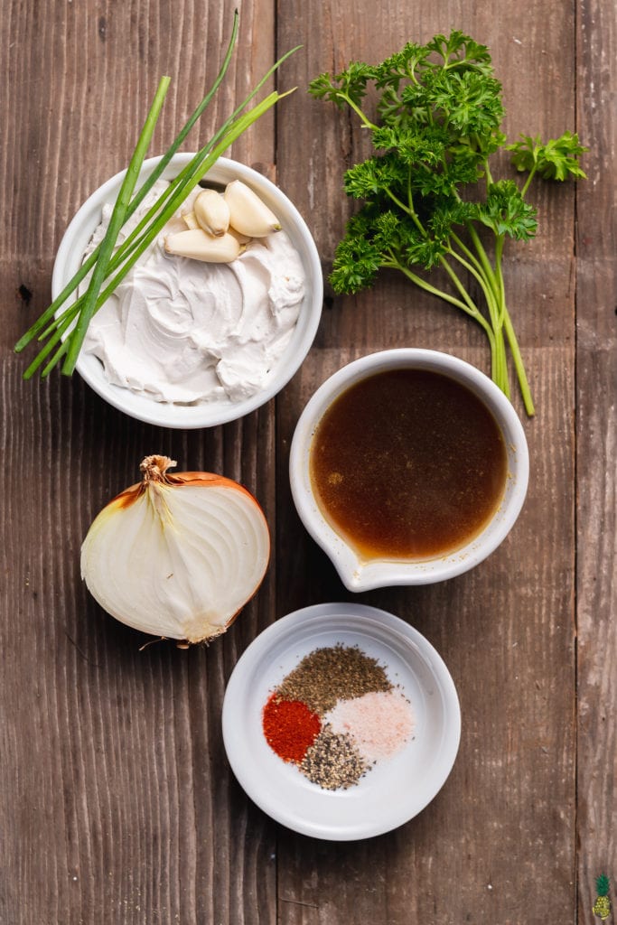 Ingredients for Vegan French Onion Dip laid out on a wooden surface