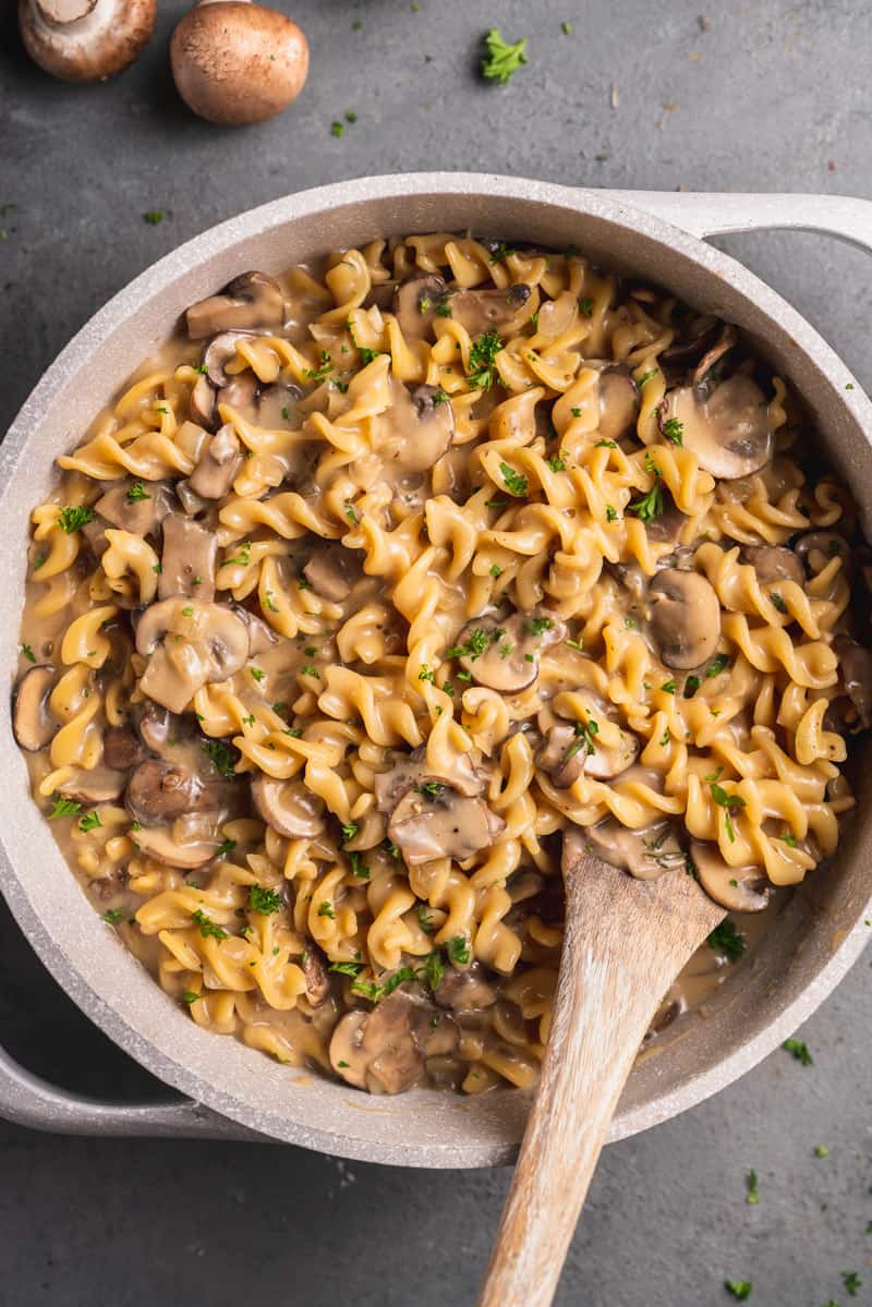 overhead image of mushroom stroganoff in large pot with done spoon.