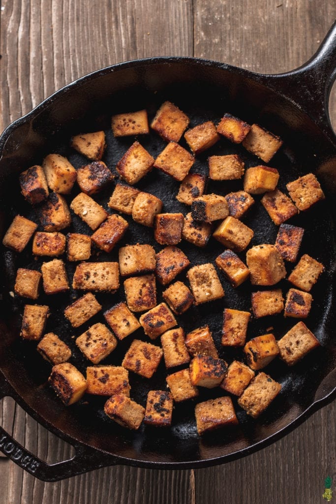 overhead image of ginger sesame tofu in a cast iron skillet