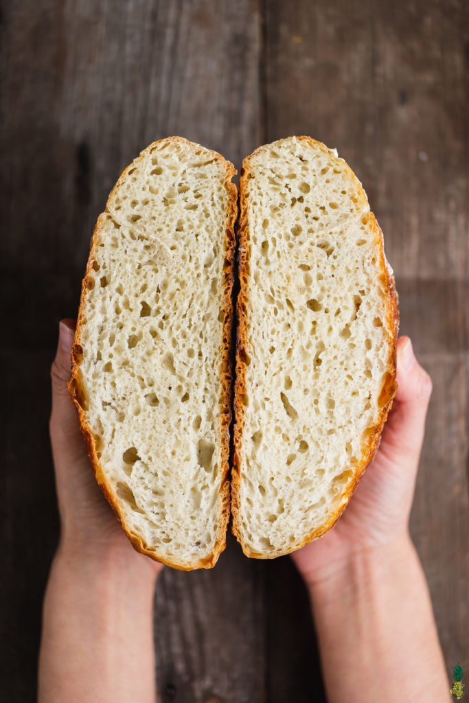sliced fresh bread being held by sweet simple vegan