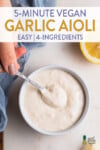 Scooping a bowl of homemade garlic aioli by sweet simple vegan for pinterest