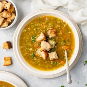 overhead image of split pea soup with croutons on top and on the side