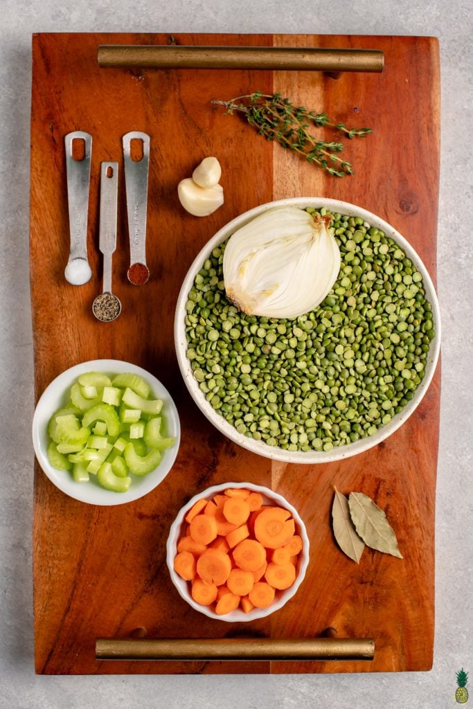 ingredients to make easy split pea soup on a wooden board