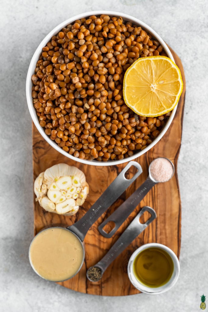 Ingredients for 5 minute lentil hummus on a wooden board by sweet simple vegan