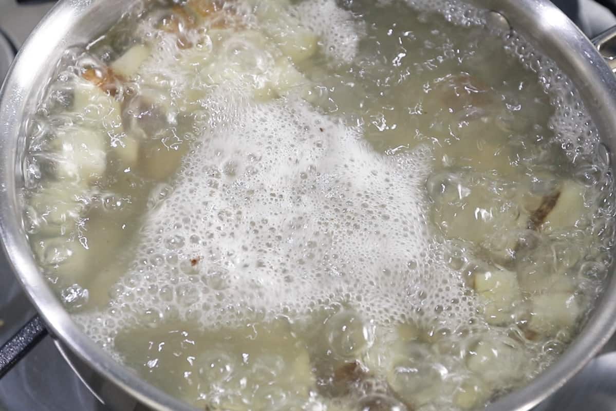 potatoes boiling in stainless steel pot