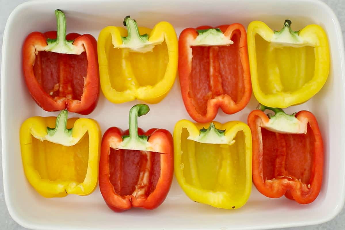 hollowed out bell peppers in white baking dish