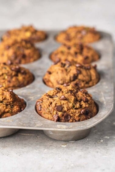 macro image of chocolate chip zucchini muffins in cupcake tin