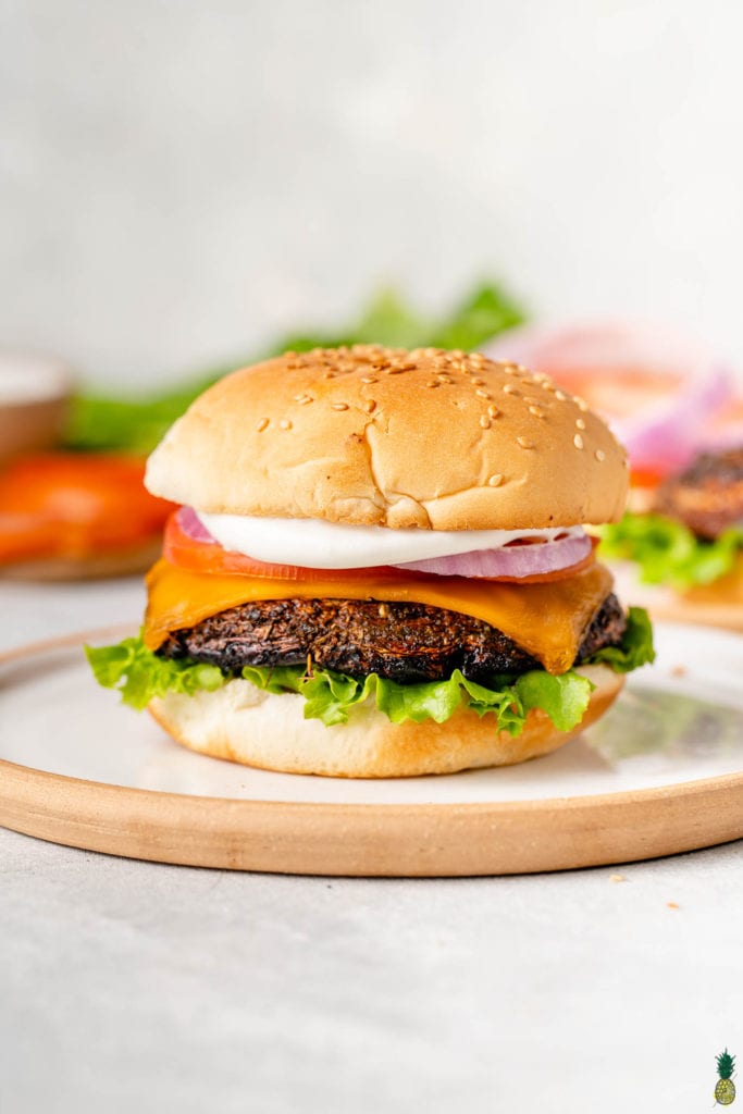 straight forward image of grilled portobello mushroom burger on plate