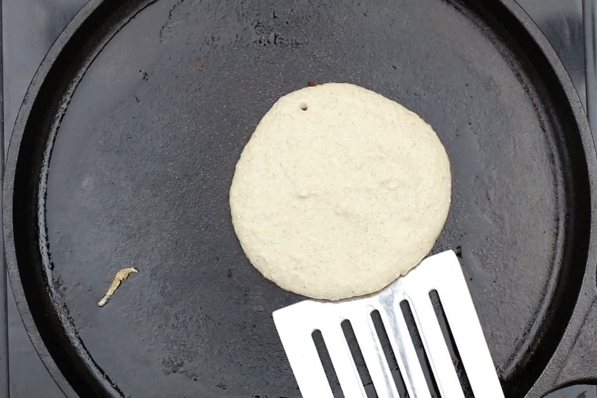 flipping pancake on cast iron griddle