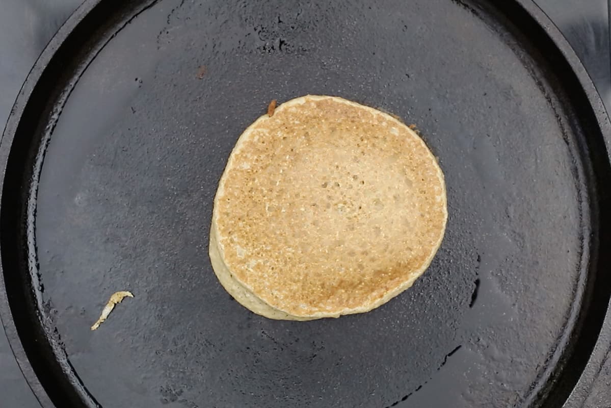 cooking pancake batter on cast iron griddle