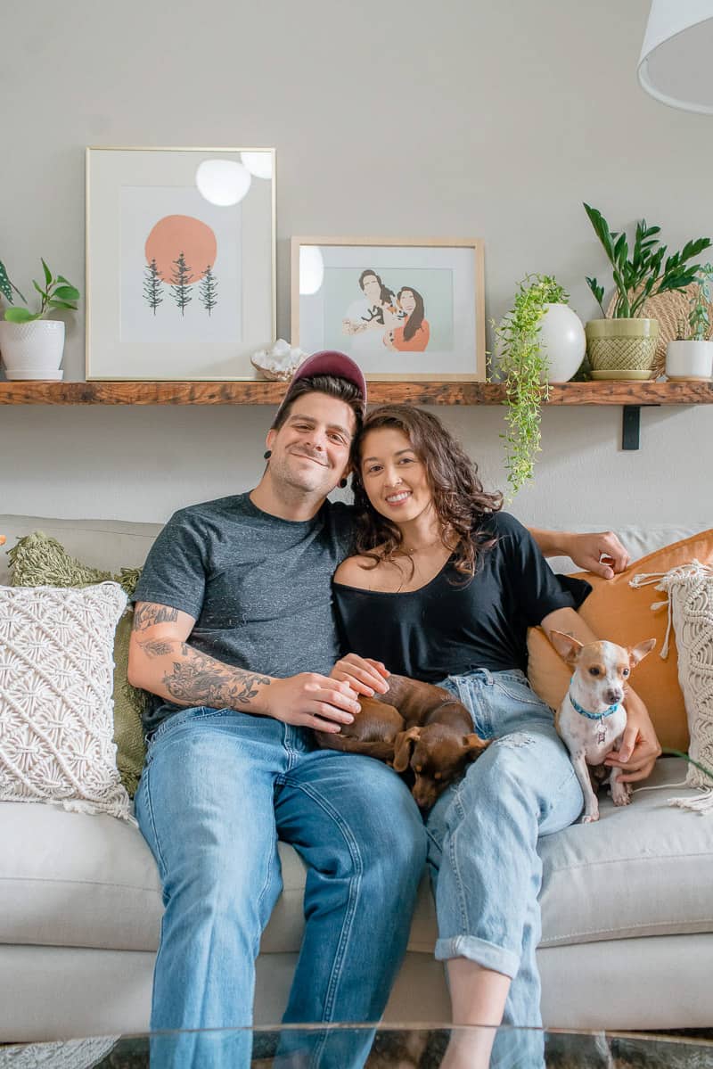 Chris and Jasmine sitting on couch with the dogs