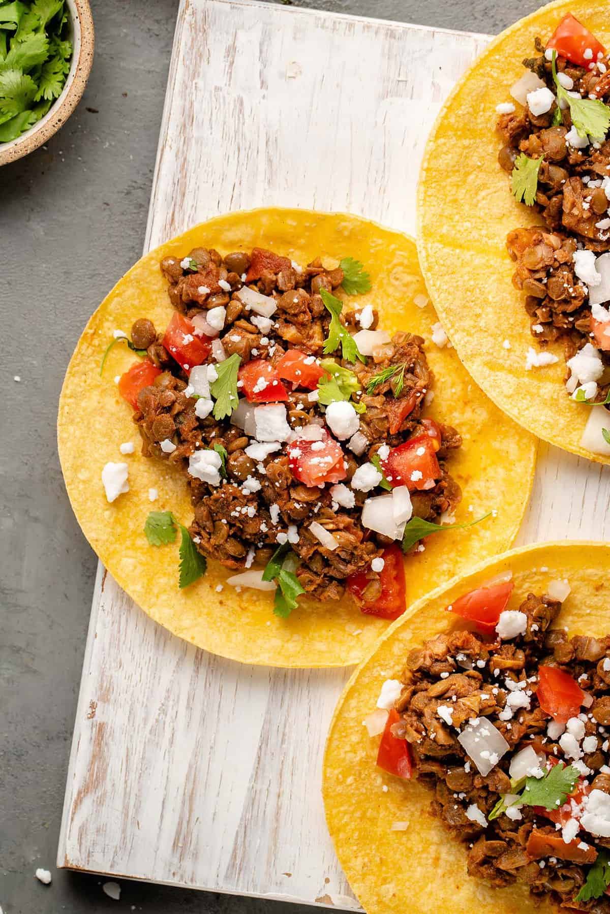 open taco on white board filled with lentil walnut taco meat