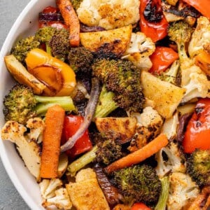a close up of roasted vegetables in a white bowl