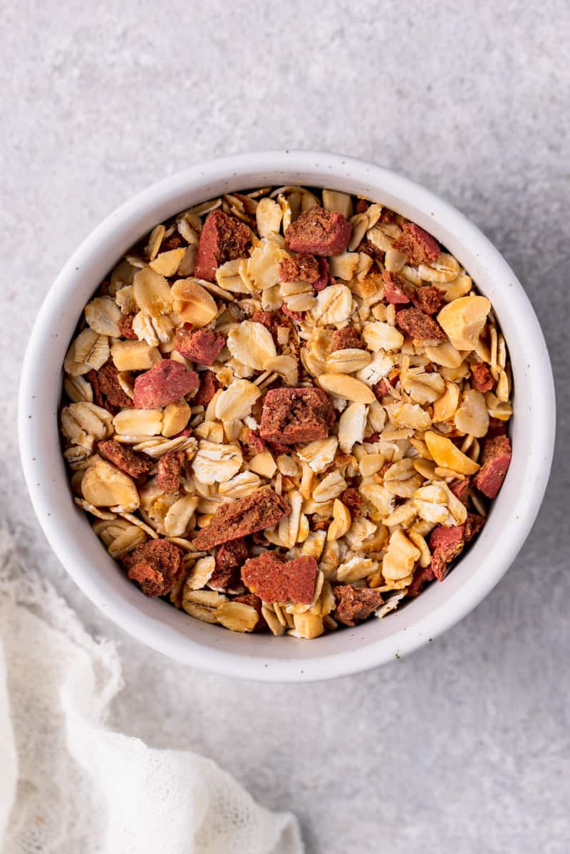 overhead image of granola in bowl with dog treats