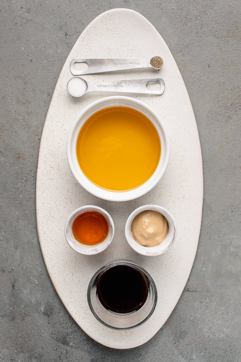 overhead image of balsamic vinaigrette ingredients on white speckled tray.
