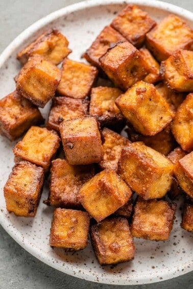 crispy baked tofu on a white speckled plate