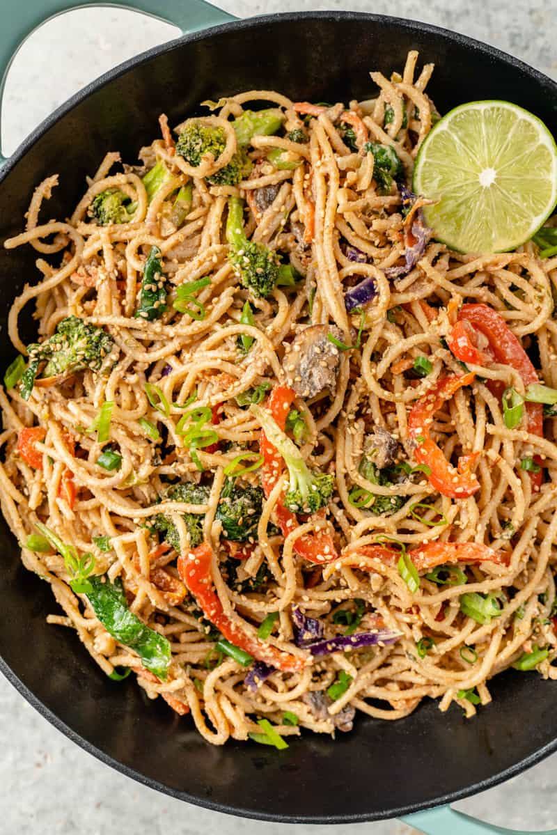 close up image of vegetable stir fry with peanut sauce in a wok