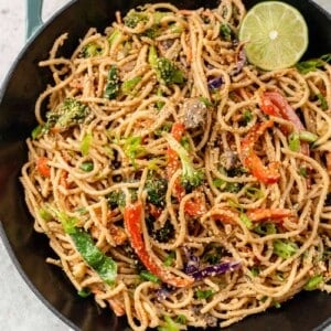 overhead image of wok filled with easy vegetable stir fry with peanut sauce