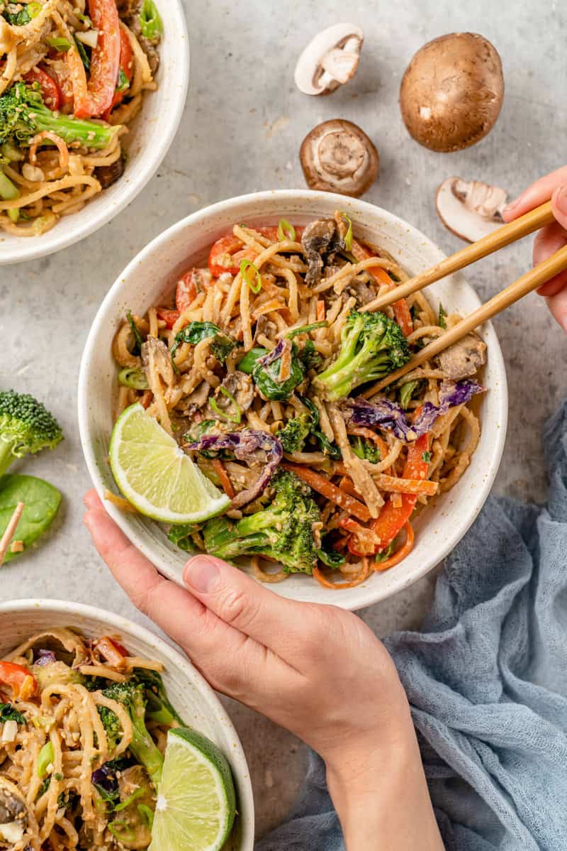 overhead image of stir fry noodle bowl with chopsticks