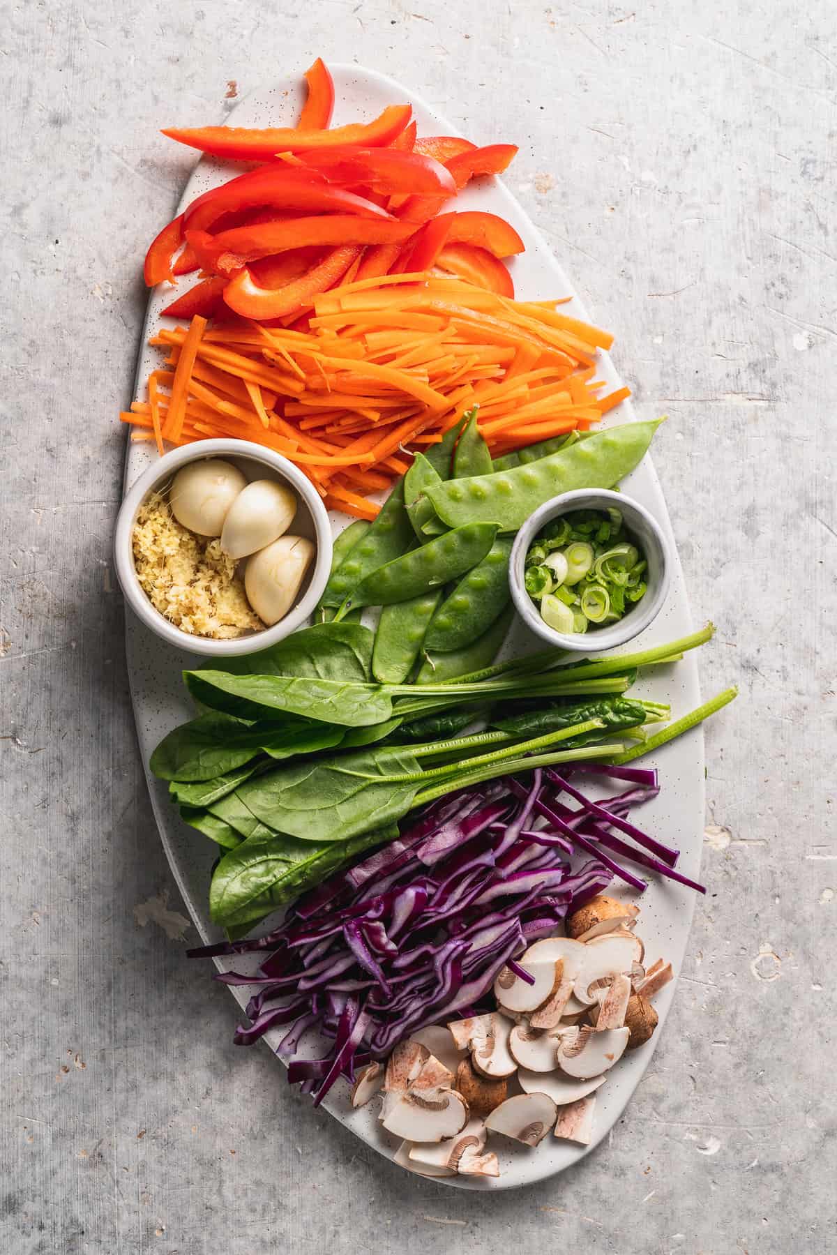 overhead image of stir fry ingredients on white platter