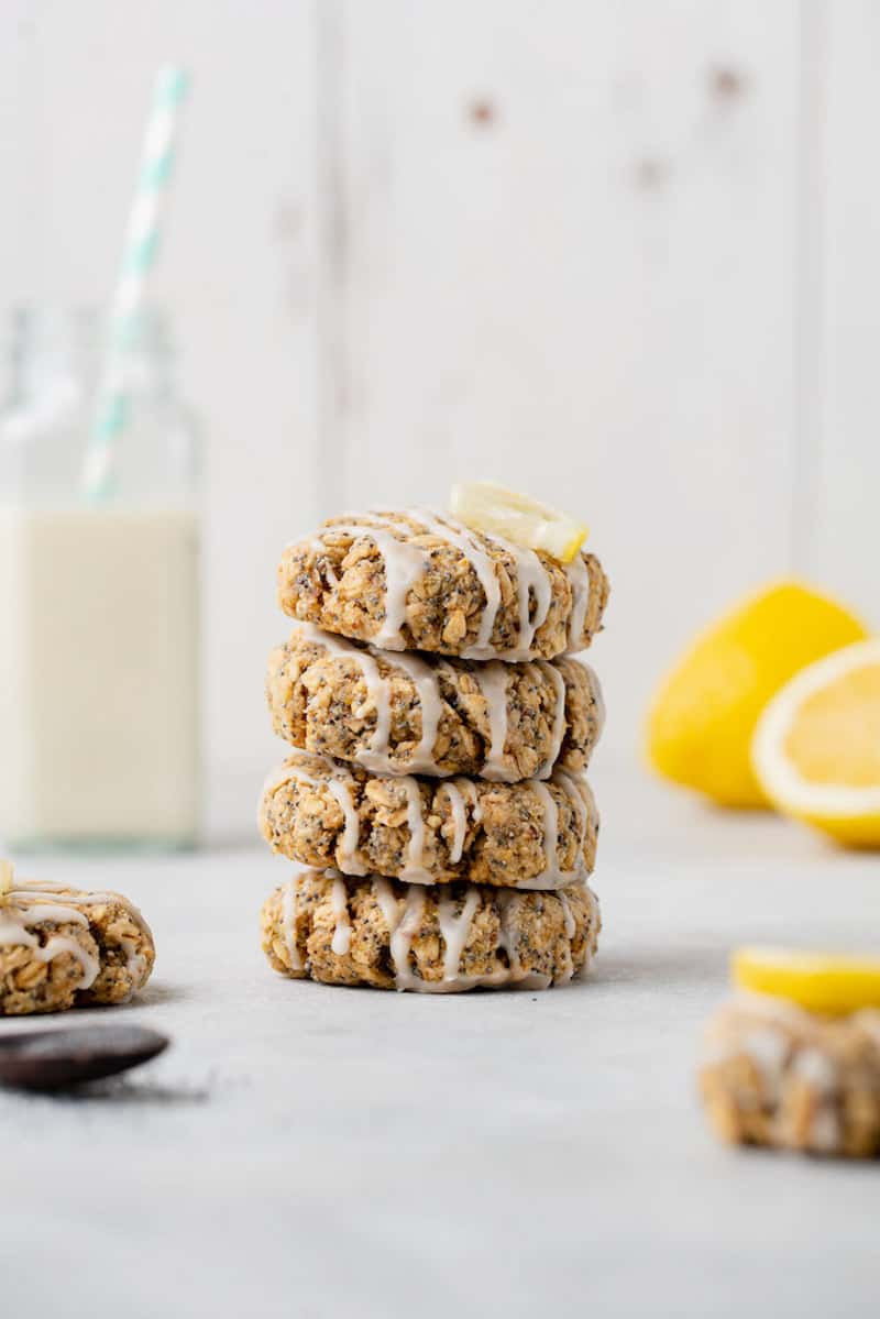 macro image of stacked lemon poppyseed cookies on white styled background