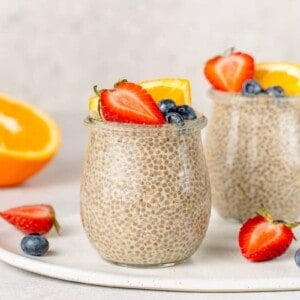 Close up shot of orange creamsicle chia pudding with fruit on top by sweetsimplevegan