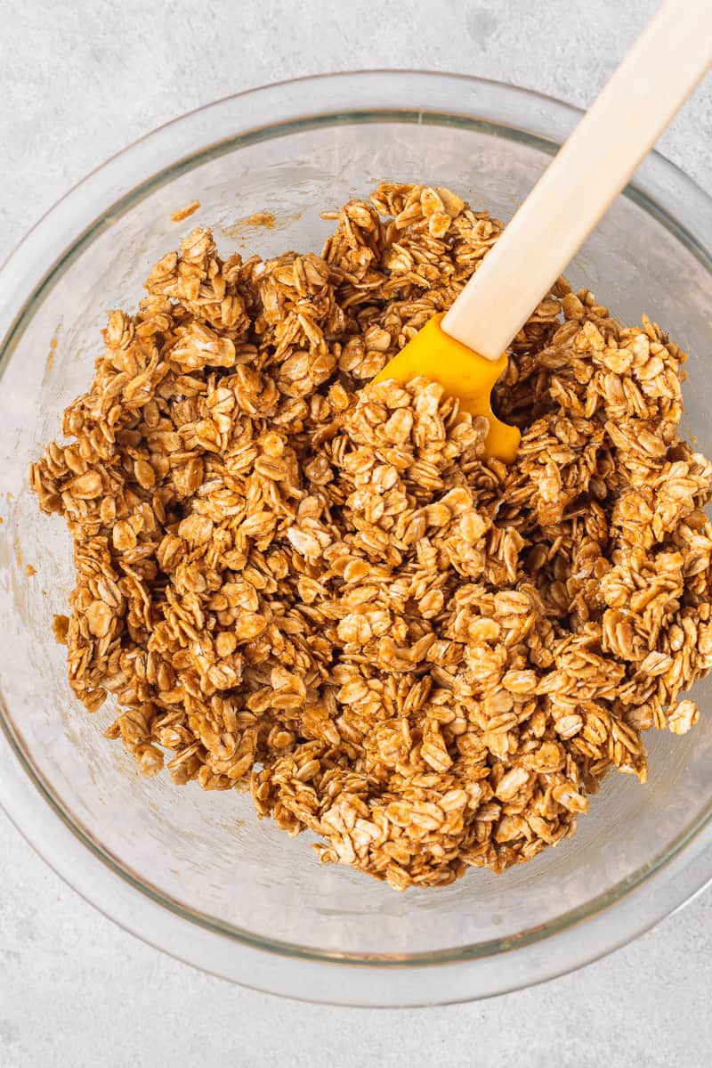 Overhead image of bowl of granola with spatula by sweetsimplevegan