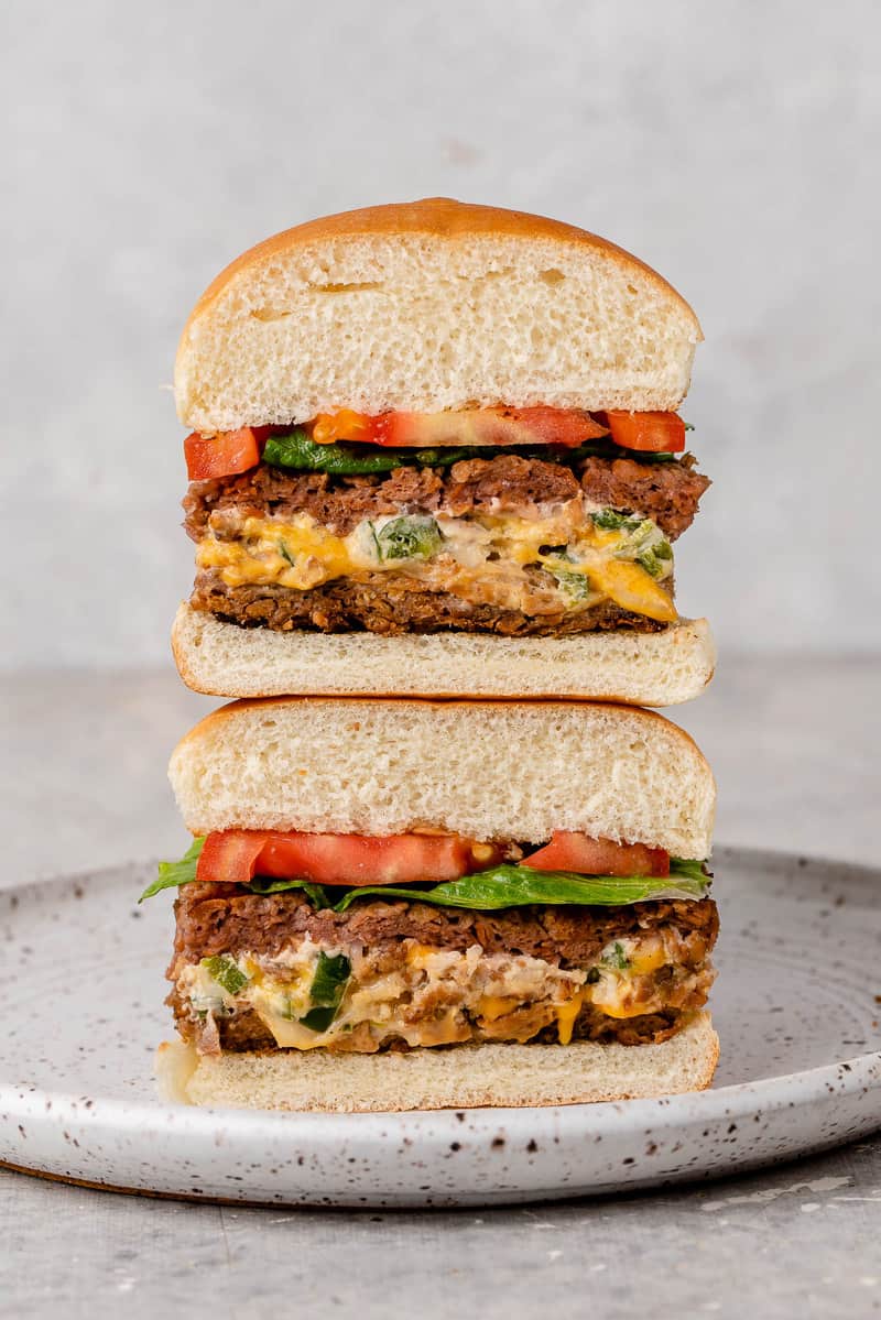 Straight forward image of stuffed jalapeño burgers on white background.